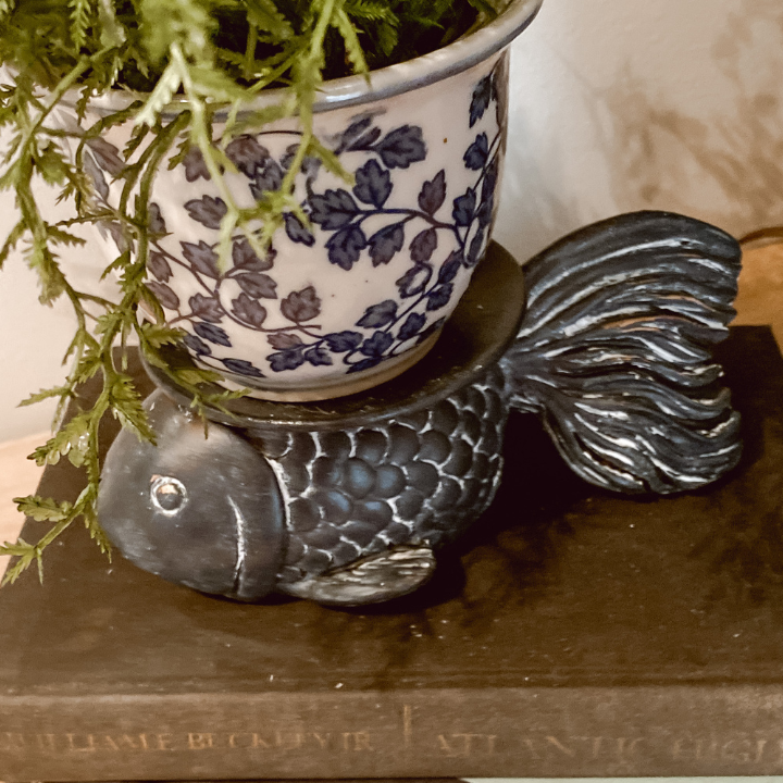 blue fish with white wax with blue and white planter with greenery