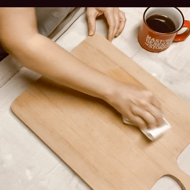 woman staining cutting board with coffee