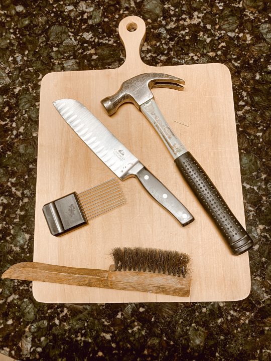 knife, hammer,wire brush on cutting board