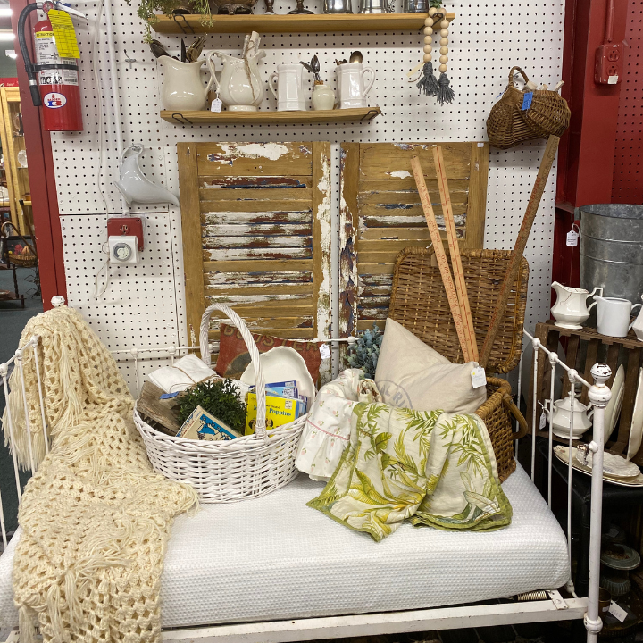 iron daybed and chippy shutters displayed in a vintage booth 